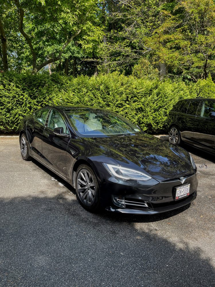 Black Porsche Panamera detailed in a driveway