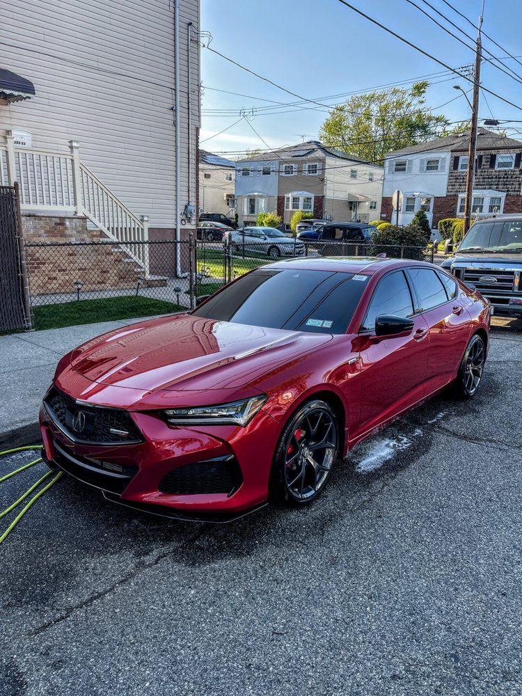 Red Acura TLX being hand washed
