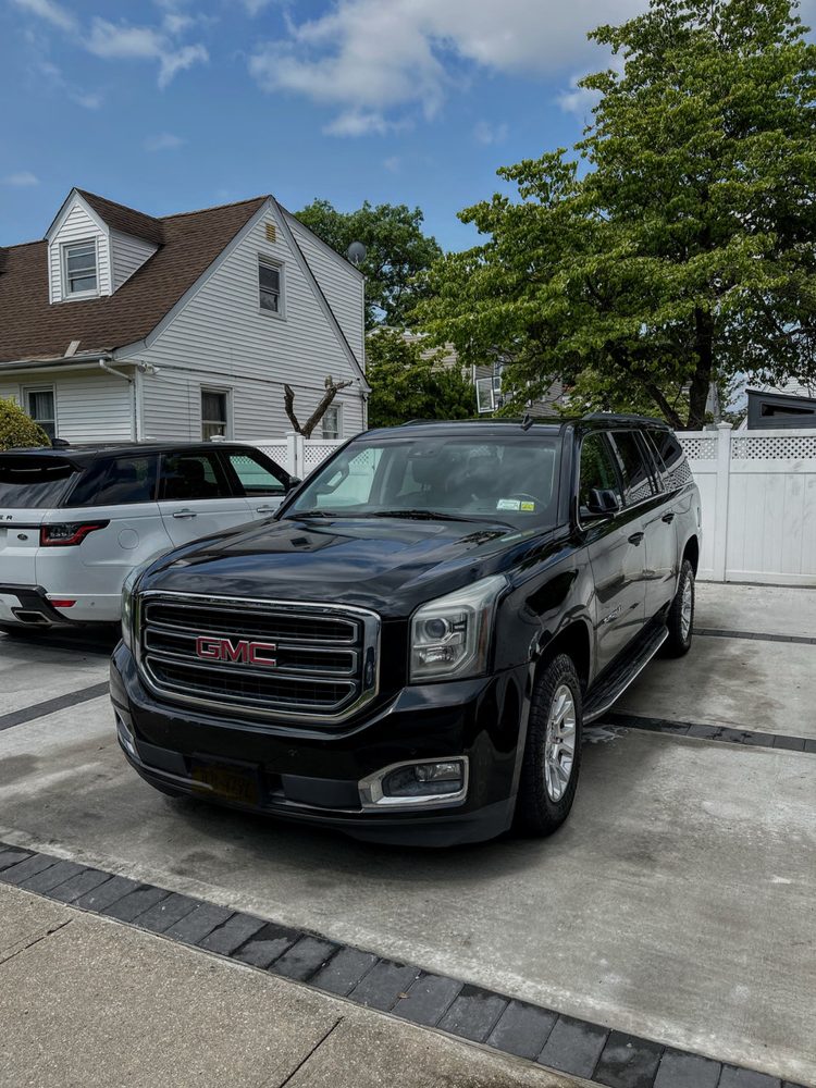 Black GMC Yukon detailed outside a home